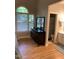 Bedroom with ensuite bathroom, a dresser, and a large window overlooking a landscaped yard at 352 Riverstone Dr, Clayton, NC 27527