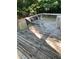 Outdoor deck area with table and chairs surrounded by lush trees offering shaded space at 352 Riverstone Dr, Clayton, NC 27527