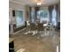 Open dining area with large windows, patterned drapes, and a table with seating for six at 352 Riverstone Dr, Clayton, NC 27527