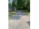Long driveway leading to a well-maintained home, surrounded by mature trees at 352 Riverstone Dr, Clayton, NC 27527