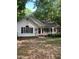 Charming single-story home featuring a red front door and covered porch at 352 Riverstone Dr, Clayton, NC 27527