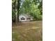 A cozy home nestled among mature trees on a sprawling lot at 352 Riverstone Dr, Clayton, NC 27527