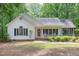 Attractive single-Gathering home with a covered front porch, black shutters, and lush landscaping enhancing curb appeal at 352 Riverstone Dr, Clayton, NC 27527