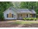 Inviting single-Gathering home featuring a covered porch, black shutters, and mature landscaping for a welcoming appearance at 352 Riverstone Dr, Clayton, NC 27527