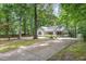 Charming, traditional home with a covered porch, well-manicured landscaping, and a long driveway leading to the residence at 352 Riverstone Dr, Clayton, NC 27527