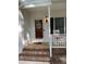 Inviting front porch with brick steps and a charming rocking chair at 352 Riverstone Dr, Clayton, NC 27527