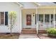 Inviting front porch with brick steps, white railing, and a decorative door creating a welcoming entrance at 352 Riverstone Dr, Clayton, NC 27527