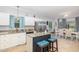 Open concept kitchen with granite countertops, stainless steel appliances, and a breakfast bar connecting to the dining area at 352 Riverstone Dr, Clayton, NC 27527