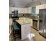 Bright kitchen features granite countertops, stainless steel appliances, an island, and white cabinetry at 352 Riverstone Dr, Clayton, NC 27527