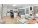 Bright eat-in kitchen showcasing white cabinets, tile floors, and stainless steel refrigerator at 352 Riverstone Dr, Clayton, NC 27527