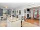 Modern kitchen with granite island open to the dining area, complemented by tile floors and ample natural light at 352 Riverstone Dr, Clayton, NC 27527