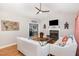 Inviting living room featuring a fireplace, hardwood floors, and an open layout leading to the adjacent kitchen at 352 Riverstone Dr, Clayton, NC 27527