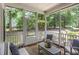 Inviting screened porch with comfortable seating and serene views of the surrounding landscape at 352 Riverstone Dr, Clayton, NC 27527