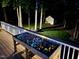Outdoor deck space with vibrant flowers and a peaceful view of the backyard and wooded area at 3821 La Costa Way, Raleigh, NC 27610