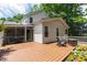 Expansive backyard deck with a grill, seating, and access to the screened-in porch and beautifully landscaped yard at 3821 La Costa Way, Raleigh, NC 27610