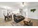 Open-concept living area showcasing a dining table, plush seating, and a view of the modern kitchen at 3821 La Costa Way, Raleigh, NC 27610