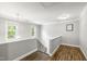 Bright upstairs hallway with wood floors, natural light, and access to multiple rooms at 3821 La Costa Way, Raleigh, NC 27610