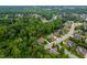 Aerial view showcasing a home situated on a wooded lot in a desirable neighborhood at 3994 Limerick Dr, Burlington, NC 27215