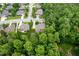 Overhead view highlighting a property in a wooded neighborhood with manicured lawns at 3994 Limerick Dr, Burlington, NC 27215