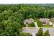 Stunning aerial view of brick home surrounded by lush, mature trees and landscaped lawn at 3994 Limerick Dr, Burlington, NC 27215