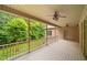 A covered outdoor porch offers serene views, ceiling fans, and a great space for relaxing outdoors at 3994 Limerick Dr, Burlington, NC 27215