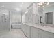 A luxurious primary bathroom features double sinks, a soaking tub, and a glass-enclosed shower at 3994 Limerick Dr, Burlington, NC 27215