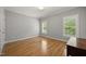 Cozy bedroom featuring hardwood floors and natural light at 3994 Limerick Dr, Burlington, NC 27215