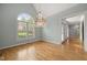Bright dining room with hardwood floors, chandelier, and large window at 3994 Limerick Dr, Burlington, NC 27215