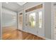 Bright foyer with decorative glass front door, sidelights, transom and gleaming hardwood floors at 3994 Limerick Dr, Burlington, NC 27215