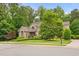 Traditional brick home with mature trees and manicured landscaping exudes timeless charm and curb appeal at 3994 Limerick Dr, Burlington, NC 27215