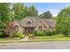 Charming brick home with manicured lawn, mature trees, and arched windows creates inviting curb appeal at 3994 Limerick Dr, Burlington, NC 27215