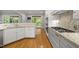 Well-lit kitchen featuring white cabinets, granite countertops, and stainless steel appliances at 3994 Limerick Dr, Burlington, NC 27215