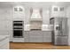 Modern kitchen featuring updated appliances, white cabinets, and granite countertops at 3994 Limerick Dr, Burlington, NC 27215