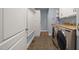 Well-organized laundry room with modern washer, dryer, and storage cabinets at 3994 Limerick Dr, Burlington, NC 27215