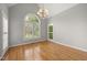 Bright living room featuring a large arched window and hardwood flooring at 3994 Limerick Dr, Burlington, NC 27215