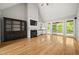 Large living room with fireplace, wet bar, hardwood floors, and access to the patio at 3994 Limerick Dr, Burlington, NC 27215