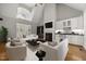 Cozy living room with a vaulted ceiling, fireplace, wet bar, and plush seating arrangement at 3994 Limerick Dr, Burlington, NC 27215