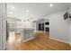 Open-concept living area with wet bar, hardwood floors, and views into the arched dining room at 3994 Limerick Dr, Burlington, NC 27215