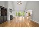 Bright living room with fireplace, built-ins, hardwood floors, and access to the outdoors at 3994 Limerick Dr, Burlington, NC 27215