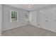 Carpeted bedroom featuring two windows with blinds and a double bi-fold door closet at 418 Old Scarborough Ln, Garner, NC 27529