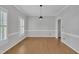 Empty dining room with hardwood floors, white trim, plantation shutters, and a modern pendant light at 418 Old Scarborough Ln, Garner, NC 27529
