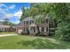 Charming two-story brick home featuring black shutters, attached garage, and well-kept lawn at 418 Old Scarborough Ln, Garner, NC 27529
