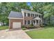 Beautiful two-story brick home featuring an attached garage, well-maintained landscaping, and a welcoming front lawn at 418 Old Scarborough Ln, Garner, NC 27529