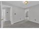 Carpeted hallway leads to three separate doorways, all painted white and a single light fixture at 418 Old Scarborough Ln, Garner, NC 27529