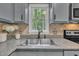 Kitchen sink beneath window with view of the yard and granite countertops at 418 Old Scarborough Ln, Garner, NC 27529