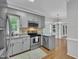 Charming kitchen features stainless steel appliances, granite countertops, and updated cabinetry at 418 Old Scarborough Ln, Garner, NC 27529
