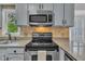 Updated kitchen features stainless appliances, tile backsplash, and granite countertops at 418 Old Scarborough Ln, Garner, NC 27529