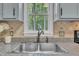 Close up of kitchen sink beneath window with view of the yard and granite countertops at 418 Old Scarborough Ln, Garner, NC 27529