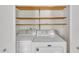 Convenient laundry area with wooden shelving and a Maytag washer and dryer at 418 Old Scarborough Ln, Garner, NC 27529