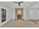 Living room featuring a brick fireplace with wooden mantle and neutral carpet and paint at 418 Old Scarborough Ln, Garner, NC 27529